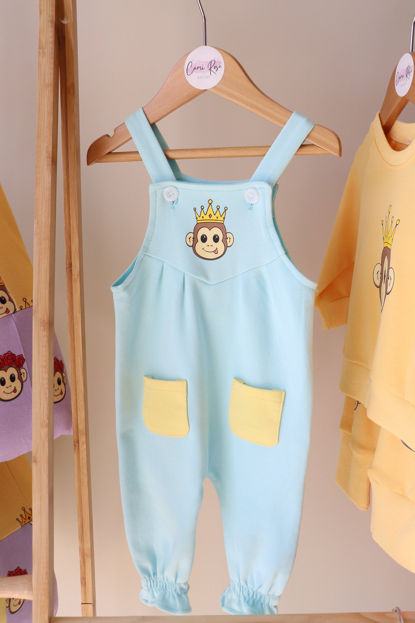 baby blue overalls with a cute monkey printed on the chest and 2 yellow pockets on the legs