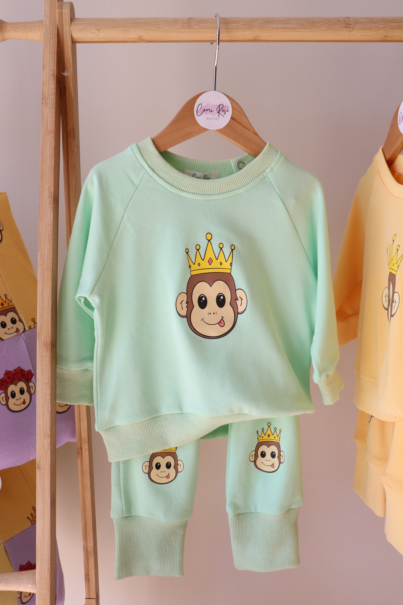 baby green lounge set with a cute monkey design printed on jumper and on the knees of pants