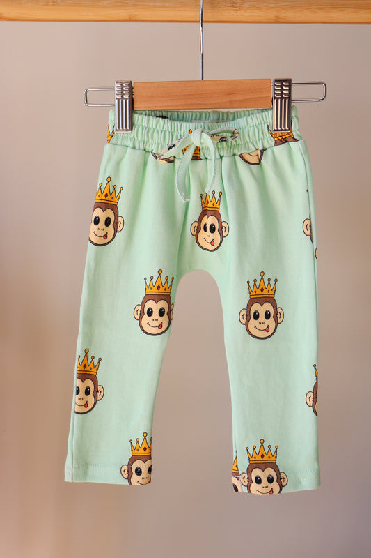 baby green pants with a cute monkey design printed all over