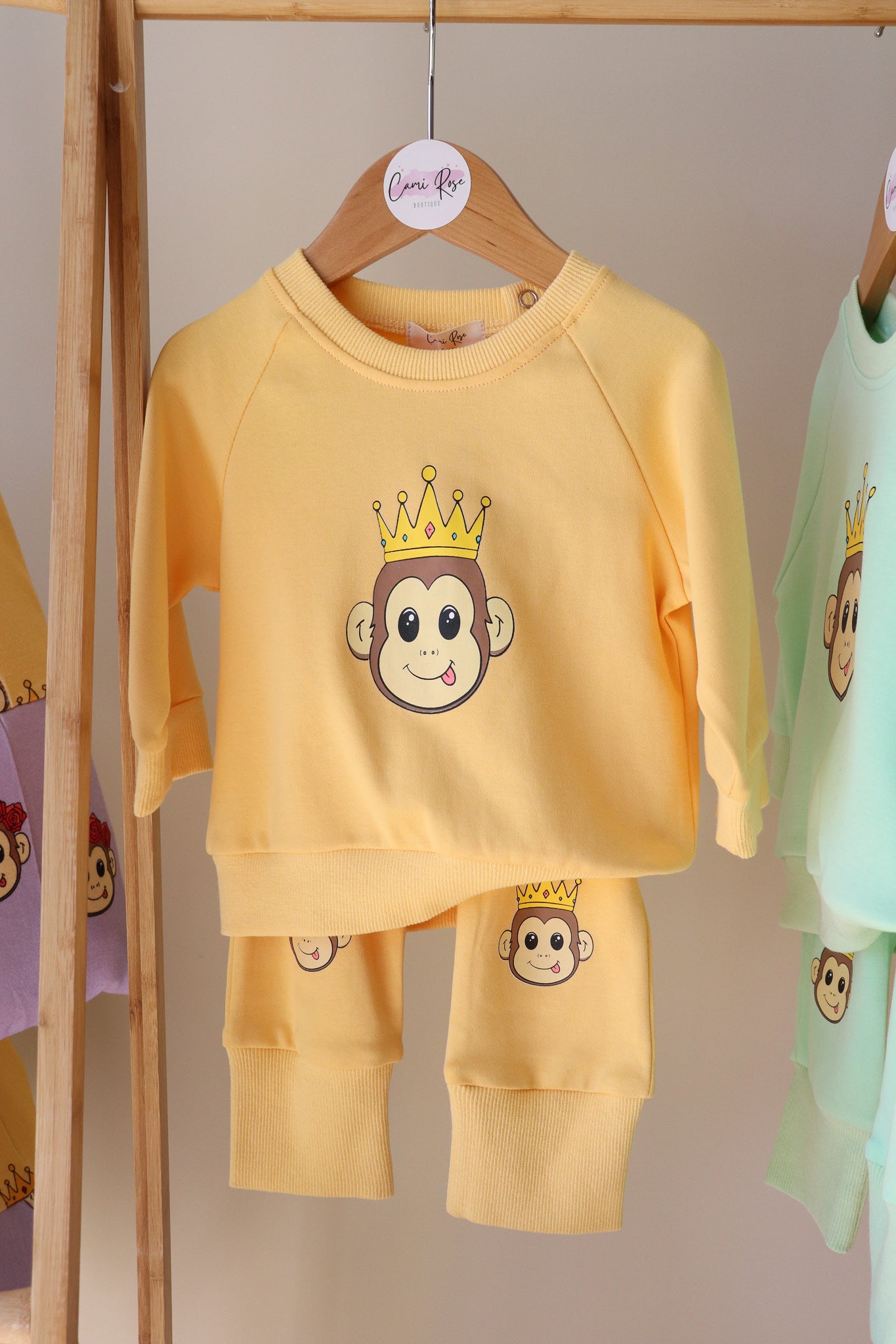 baby orange lounge set with a cute monkey printed on the jumper and on the knees of the pants