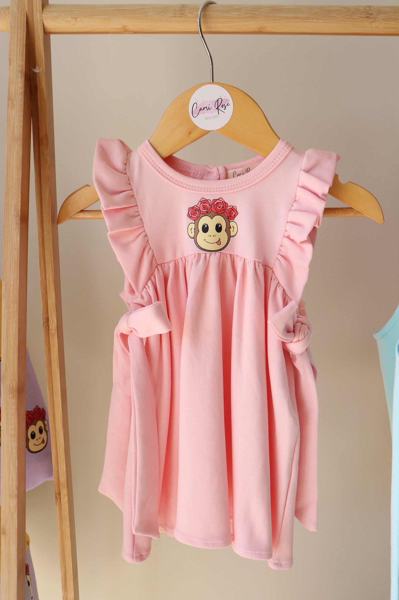 cute baby pink dress with frill sleeves and tie-up bows on each side