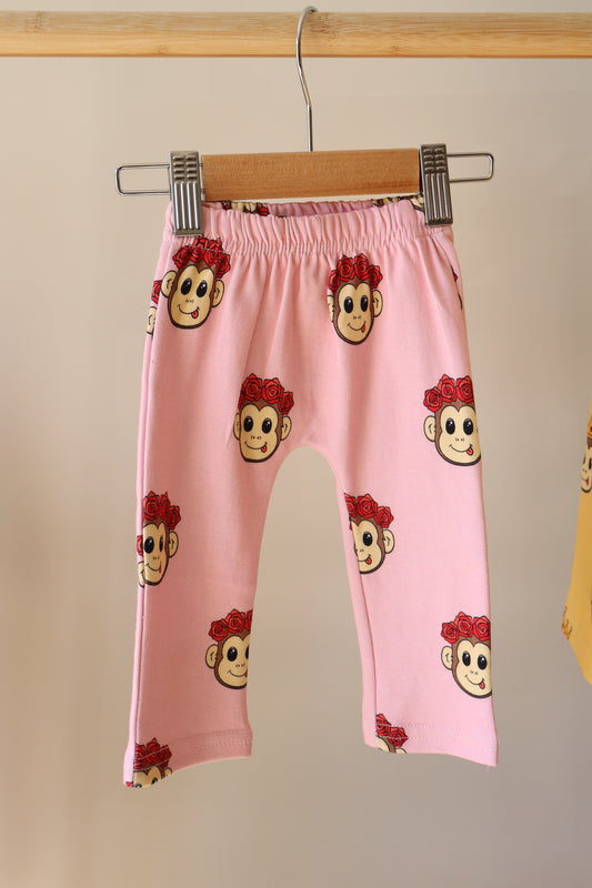 baby pink pants with a cute monkey design printed all over