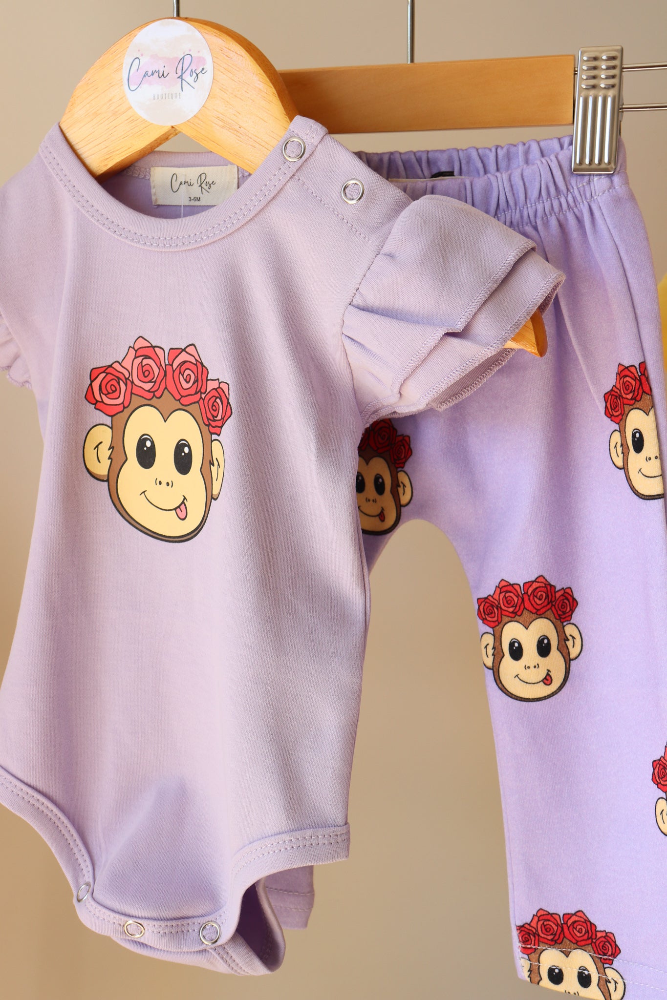 baby purple frill romper with a cute monkey design 