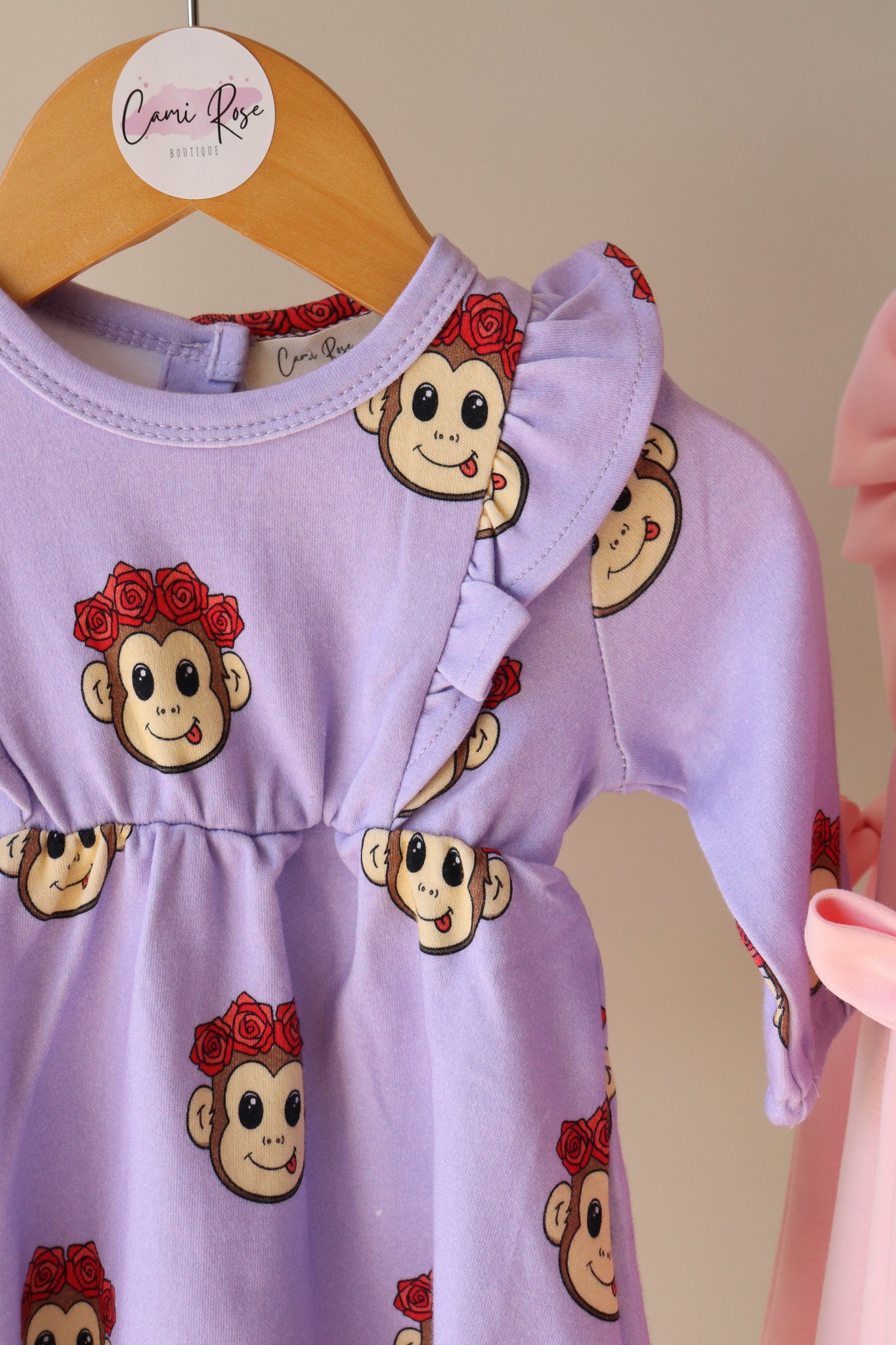 baby long sleeve dress in purple with frill sleeves and a cute monkey design printed all over