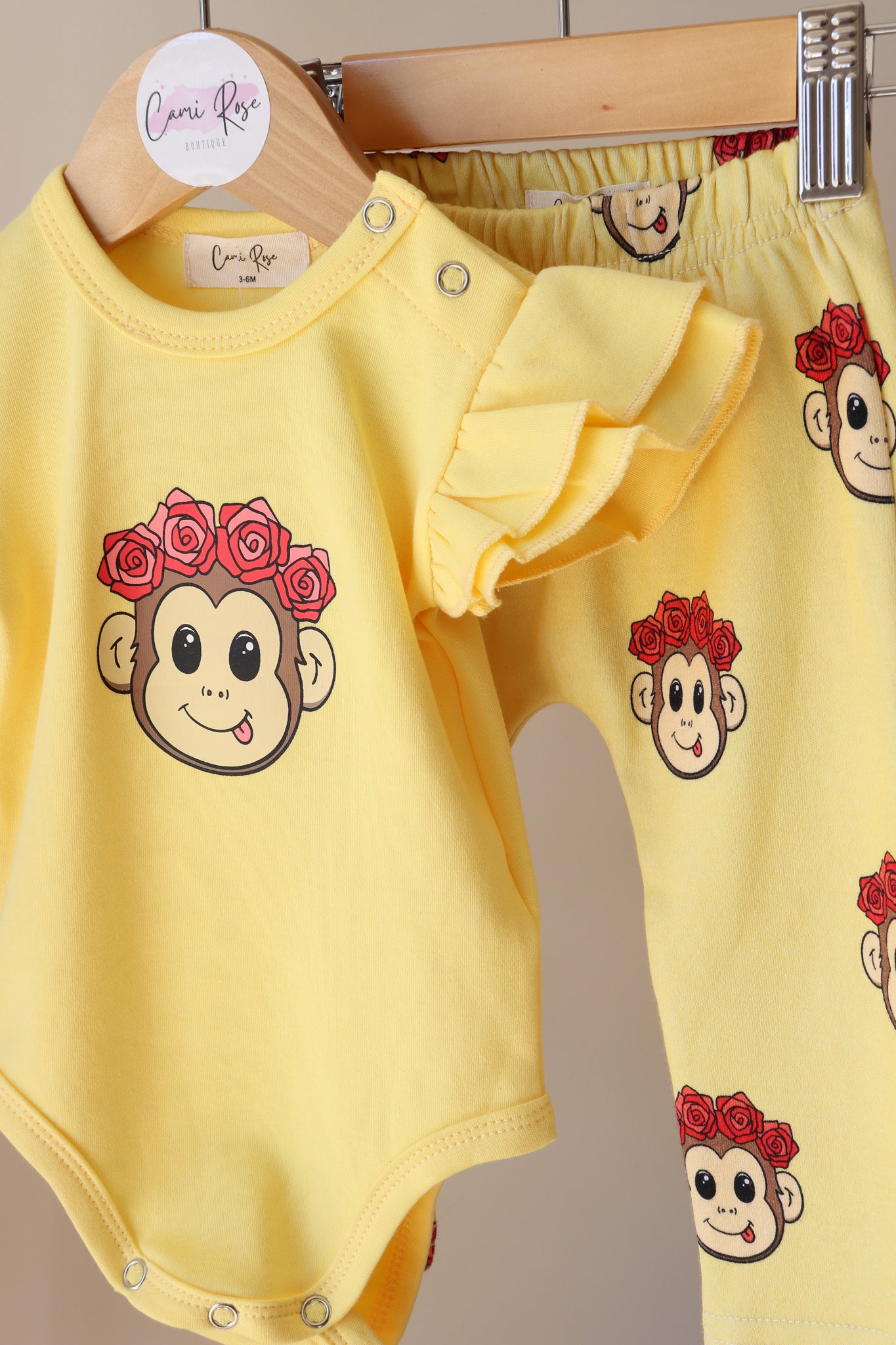 baby yellow frill romper with a cute monkey design