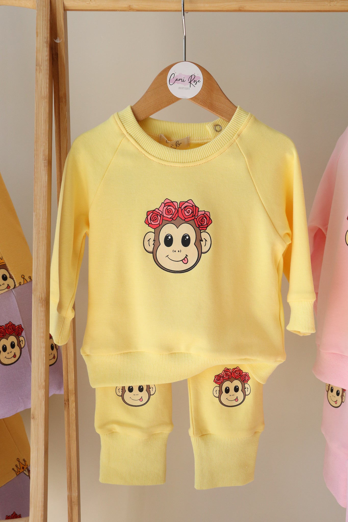 baby yellow lounge set with a cute monkey printed on the jumper and on the knees of the pants